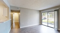 Located in Orlando, FL, this well-appointed 1-bedroom, 1-bathroom unit offers a comfortable and functional single-floor layout. Wood-look flooring runs throughout, complemented by neutral gray walls, textured ceilings, and clean white baseboards that create a bright, cohesive aesthetic.

The open-concept living and dining area is bathed in natural light from a large sliding glass door that leads directly to a private patio with outdoor views. The galley-style kitchen is a standout feature, boasting crisp white cabinetry, light quartz countertops, and a full suite of stainless steel appliances including a refrigerator, electric range, over-the-range microwave, and dishwasher. A pantry and additional closet storage add to the kitchen's practicality.

A hallway connects the main living areas to the bedroom, which is comfortably sized and features a ceiling fan, multiple windows for natural light, and a louvered bifold closet. The bathroom is clean and functional, offering a full tub/shower combo, a wide vanity with a quartz countertop, and a large mirror. In-unit laundry is also included. The layout is rounded out by two closets and additional hallway storage, making this a practical and inviting space.