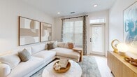 Located at 601 Cambrian Ridge Trail in Wake Forest, NC, this well-appointed single-story home offers a thoughtfully designed layout across one bedroom and one bathroom. The interior is defined by crisp white walls, light hardwood flooring, and recessed lighting that create a bright, airy ambiance throughout.

The living room is a welcoming space, featuring neutral tones, clean lines, and natural light complemented by tasteful wall art and a built-in shelving unit. It flows seamlessly into the rest of the home, making the layout feel open and connected.

The kitchen is a standout feature, boasting white shaker cabinetry with matte black hardware, a large center island with quartz countertops, stainless steel appliances, and pendant lighting — combining functionality with modern style. A louvered utility closet adds practical storage nearby.

The hallway connects the living areas to the private quarters, passing a well-sized bathroom fitted with a dual-sink white vanity, quartz countertops, dark fixtures, and a large mirror. The bedroom is a comfortable and serene retreat, featuring a ceiling fan, ample natural light, and access to a closet.

Throughout the home, consistent finishes — warm wood floors, white trim, and black hardware accents — lend a cohesive, contemporary character to this efficiently designed residence.