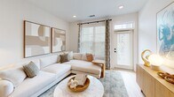 Located at 601 Cambrian Ridge Trail in Wake Forest, NC, this well-appointed single-story home offers a thoughtfully designed layout across one bedroom and one bathroom. The interior is defined by crisp white walls, light hardwood flooring, and recessed lighting that create a bright, airy ambiance throughout.

The living room is a welcoming space, featuring neutral tones, clean lines, and natural light complemented by tasteful wall art and a built-in shelving unit. It flows seamlessly into the rest of the home, making the layout feel open and connected.

The kitchen is a standout feature, boasting white shaker cabinetry with matte black hardware, a large center island with quartz countertops, stainless steel appliances, and pendant lighting — combining functionality with modern style. A louvered utility closet adds practical storage nearby.

The hallway connects the living areas to the private quarters, passing a well-sized bathroom fitted with a dual-sink white vanity, quartz countertops, dark fixtures, and a large mirror. The bedroom is a comfortable and serene retreat, featuring a ceiling fan, ample natural light, and access to a closet.

Throughout the home, consistent finishes — warm wood floors, white trim, and black hardware accents — lend a cohesive, contemporary character to this efficiently designed residence.