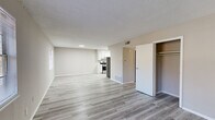 Located at 460 E Blackstock Rd in Spartanburg, SC, this single-floor, three-bedroom, two-bathroom home offers a practical and well-appointed layout. The open-concept living and kitchen area is anchored by light gray luxury vinyl plank flooring and neutral-toned walls, creating a bright and cohesive atmosphere. The kitchen stands out with crisp white cabinetry, marble-look countertops, stainless steel appliances including a gas range and refrigerator, and a double-basin sink — making it both functional and visually appealing. The living area flows seamlessly, offering ample space for everyday living. A hallway connects the common areas to the private quarters, which include three bedrooms. The primary bedroom features its own closet, while additional bedrooms are finished with plush carpeting and benefit from natural light through window blinds. Two closets provide added storage throughout. The two bathrooms are clean and efficiently designed, each featuring marble-look countertops, white vanity cabinetry, mirrored medicine cabinets, and a tub/shower combination. Textured ceilings add a classic touch throughout the home, while consistent neutral tones and modern finishes lend the space a fresh, move-in-ready feel.