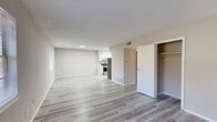Located at 460 E Blackstock Rd in Spartanburg, SC, this single-floor, three-bedroom, two-bathroom home offers a practical and well-appointed layout. The open-concept living and kitchen area is anchored by light gray luxury vinyl plank flooring and neutral-toned walls, creating a bright and cohesive atmosphere. The kitchen stands out with crisp white cabinetry, marble-look countertops, stainless steel appliances including a gas range and refrigerator, and a double-basin sink — making it both functional and visually appealing. The living area flows seamlessly, offering ample space for everyday living. A hallway connects the common areas to the private quarters, which include three bedrooms. The primary bedroom features its own closet, while additional bedrooms are finished with plush carpeting and benefit from natural light through window blinds. Two closets provide added storage throughout. The two bathrooms are clean and efficiently designed, each featuring marble-look countertops, white vanity cabinetry, mirrored medicine cabinets, and a tub/shower combination. Textured ceilings add a classic touch throughout the home, while consistent neutral tones and modern finishes lend the space a fresh, move-in-ready feel.