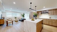 This elegant single-story home in Beverly Hills showcases contemporary design and luxurious living. The property boasts 2,460 square feet of thoughtfully designed space, including three bedrooms and four bathrooms. The heart of the home features an open-concept living area with a sleek kitchen, adorned with light wood cabinetry, marble countertops, and a central island. Large windows throughout allow natural light to flood the space, enhancing the airy atmosphere.

The primary bedroom suite is a standout feature, occupying an impressive 1,220 square feet - nearly half of the home's total area. This retreat offers ample space for relaxation and includes a walk-in closet with custom built-ins. The bathrooms exhibit modern aesthetics with clean lines, featuring high-end fixtures and finishes such as floating vanities and marble accents.

Throughout the residence, a neutral color palette creates a calm and sophisticated ambiance. The living spaces are adorned with carefully curated furniture and decor, including plush seating and artistic elements. An outdoor balcony provides a serene spot to enjoy the Beverly Hills climate, complete with sleek glass railings and views of surrounding greenery.

The property's attention to detail extends to its lighting design, with recessed ceiling lights and designer fixtures enhancing the modern aesthetic. Hardwood floors flow seamlessly through the home, unifying the space and adding warmth to the contemporary design. This Beverly Hills address offers a perfect blend of luxury, comfort, and style in one of Los Angeles' most coveted neighborhoods.