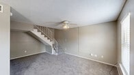 Located at 5151 Highland Rd in Baton Rouge, Louisiana, this two-story residence offers 2 bedrooms and 3 bathrooms spread across two well-defined floors. The main level features a carpeted living room with a ceiling fan, natural light from multiple windows, and hard surface flooring at the entryway. A galley-style kitchen is equipped with gray cabinetry, a double-basin stainless steel sink, electric range, refrigerator, and dishwasher, all set on wood-look flooring. A staircase with white railings connects the main level to the upper floor. Both bedrooms are carpeted and receive natural light through windows with blinds. The primary bedroom includes a louvered double-door closet for ample storage. The three bathrooms are functional and clean in design; one features a granite-style vanity countertop with lighted mirror, while another includes a full tub and shower combination. Textured ceilings are consistent throughout the unit. The layout is efficient, with the lower floor housing the main living and kitchen areas, and the upper floor dedicated to the bedrooms and bathrooms, making for a clear separation between living and sleeping spaces.