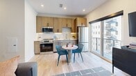 Located at 700 North Delaware Avenue in Philadelphia's vibrant Northern Liberties neighborhood, this one-bedroom, one-bathroom unit offers a thoughtfully designed single-floor layout that maximizes every inch of its compact footprint. Light hardwood flooring flows throughout, connecting each room cohesively.

The entry hallway sets a clean, modern tone with recessed lighting and a built-in wall shelf with hooks — a practical and stylish welcome. The open-concept living and kitchen area is the heart of the unit. The kitchen is equipped with warm wood cabinetry extending to the ceiling, stainless steel appliances including a full-size refrigerator, range, microwave, and dishwasher, complemented by a light stone countertop and subway tile backsplash. A sliding glass door opens to a private balcony, allowing natural light to flood the space and offering outdoor views. The living area features a distinctive terrazzo-style accent wall that adds texture and character.

The bedroom is a cozy, well-appointed retreat with a high transom window providing soft ambient light. The bathroom offers clean, neutral tile flooring, a tub-shower combination, and crisp white finishes throughout. A dedicated closet completes the layout, providing practical storage in this efficient yet stylish urban residence.