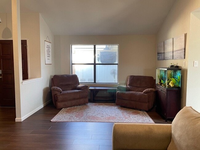 Second lounge area with oversized chairs and big windows - great for reading or hosting. - 2401 Thistle Ct