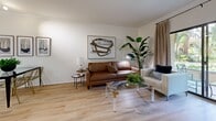 Located at 550 N Figueroa in downtown Los Angeles, this 2-bedroom, 1-bathroom residence offers a well-organized single-level layout with thoughtful finishes throughout. Light hardwood flooring flows through the living areas and bedrooms, creating a warm and cohesive aesthetic.

The living room is an inviting space featuring crown molding, neutral walls, and a sliding glass door that opens to a private outdoor area with lush greenery views, allowing natural light to fill the room.

The galley-style kitchen is efficiently designed with light maple cabinetry, dark granite countertops, white tile flooring, and stainless steel appliances including a gas range, built-in microwave, refrigerator, and dishwasher. A breakfast bar adds additional counter space and functionality.

The primary bedroom is a generously sized retreat with large windows dressed in sheer white curtains, hardwood flooring, and a warm earth-toned accent wall. A hallway connects the rooms, offering a clean transition through the space.

The bathroom is well-appointed with light maple cabinetry, dark granite countertops, a framed mirror, and a full tub-shower combination with sliding glass doors, complemented by tile flooring throughout.