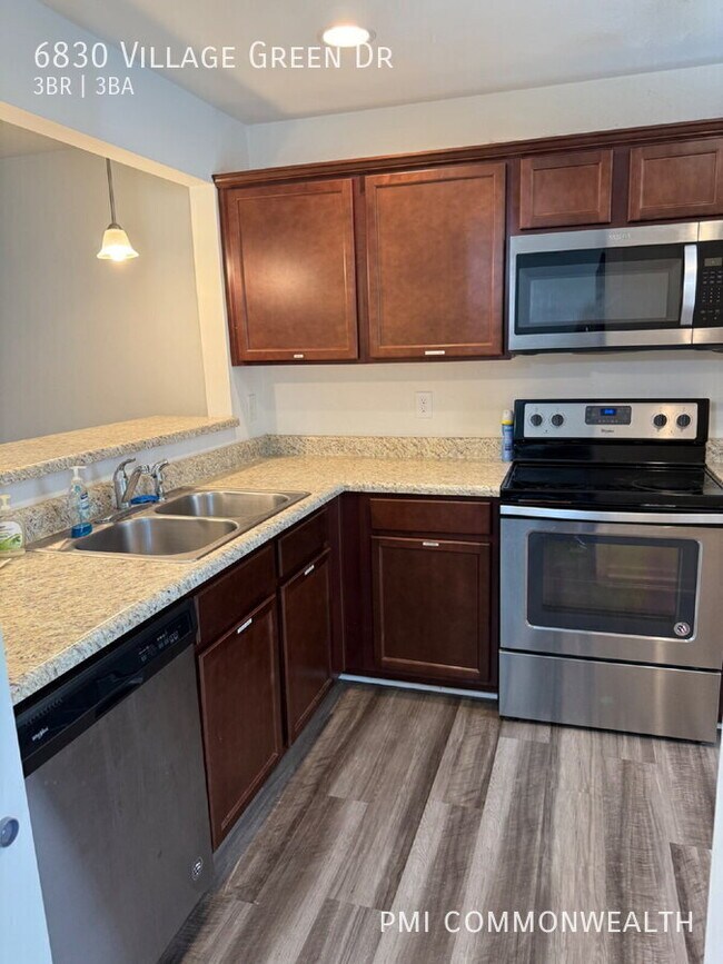 Building Photo - 6830 Village Green Dr