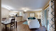 Located in Orlando, FL, this 2-bedroom, 2-bathroom residence offers a practical and comfortable single-floor layout. The open-concept living and dining area is anchored by rich hardwood-style flooring, warm neutral-toned walls, and a ceiling fan, creating an inviting atmosphere. Sliding glass doors in the living room allow natural light to pour in and provide access to an outdoor area. The adjacent dining space offers a dedicated area for meals and entertaining.

The galley-style kitchen features white cabinetry, dark granite-look countertops, stainless steel appliances, and hardwood-style flooring, balancing function and style. Both bedrooms are carpeted and include ceiling fans; the primary bedroom features a walk-in closet, while the secondary bedroom benefits from natural light and direct access to a full bathroom. Each bathroom is finished with dark countertops, white cabinetry, and a shower-tub combination.

Additional highlights include a dedicated in-unit laundry room with a full-size washer and dryer, two closets for ample storage, and a textured ceiling throughout. The cohesive warm-toned palette and thoughtful layout make this a well-rounded, move-in ready residence.