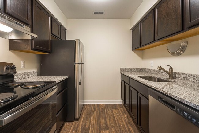 Upgraded Kitchen with stainless steel appliances and granite countertops at Westwood Village Apartments in Westland, MI - Westwood Village Apartments