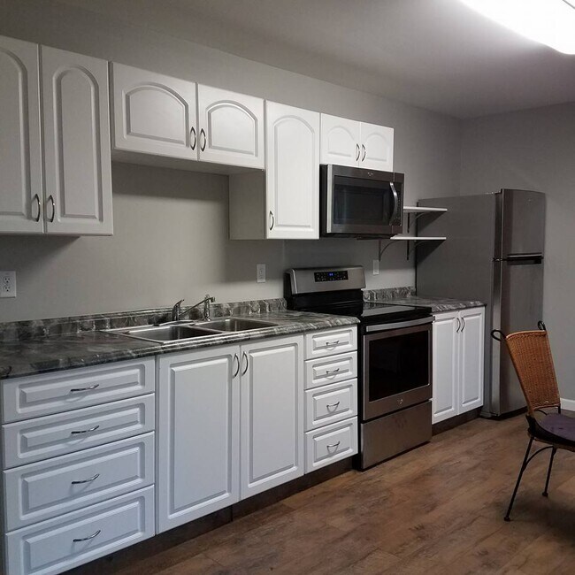 Plenty of storage. Pull out shelves with the base cabinets. Open shelving next to microwave. Sta - 15 Marlborough Dr