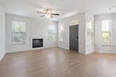 Located in Birmingham, AL, this well-appointed single-story home offers a thoughtfully designed open-concept layout that seamlessly connects the kitchen, dining, and living areas. The kitchen is outfitted with dark wood cabinetry, a subway tile backsplash, white quartz countertops, a peninsula with an undermount sink, stainless steel dishwasher, and pendant lighting — all overlooking the main living space. The dining nook features a bay window configuration that floods the area with natural light, while the living room includes a fireplace and ceiling fan. Light wood-tone flooring flows throughout the main living areas, adding warmth and continuity. The spacious primary bedroom features a bay window, plush carpeting, and a walk-in closet with wire shelving for organized storage. The second bedroom also offers carpet flooring, a ceiling fan, and a bright window. Both bathrooms are finished with wood-toned vanities, white countertops, and tub/shower combinations with tiled surrounds. A dedicated laundry room houses a full-size washer with overhead shelving. The attached single-car garage provides direct interior access and additional storage potential. Four closets throughout the home ensure ample storage for everyday living.