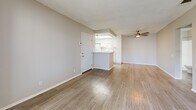 Located at 43530 Gadsden Ave in Lancaster, CA, this single-floor 2-bedroom, 2-bathroom unit offers a functional and well-organized layout. The combined living room and kitchen area forms the heart of the home, featuring light wood-style flooring that extends throughout the main living spaces. The living room is bright and open, anchored by a ceiling fan and connected to a private balcony through sliding glass doors that invite natural light and outdoor views. A hallway leads from the living area to the rest of the unit.

The kitchen is designed with efficiency in mind, featuring white cabinetry with ample storage, light stone-look countertops, a stainless steel sink, and white appliances including a gas range and refrigerator. A pass-through peninsula connects the kitchen to the living area, enhancing the open feel.

Both bedrooms are carpeted for comfort and include sliding-door closets. The primary bedroom is generously sized and features two windows that bring in natural light. The second bedroom also offers a large closet. Each bedroom is served by its own bathroom, both fitted with wood-style flooring, white cabinetry, stone countertops, and a tub/shower combination. Textured ceilings are present throughout, adding a consistent finish to the neutral, move-in-ready interior.