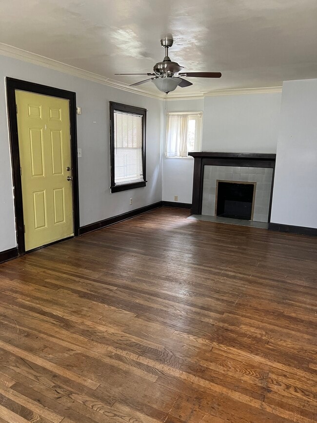 Generously sized living room with fireplace and original hardwoods - 5105 Virginia Ave