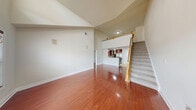 Located at 20 W Palisade Ave in Englewood, NJ, this two-bedroom, one-bathroom loft offers a thoughtfully designed two-floor layout with generous living space spread across both levels. The main floor makes an immediate impression with soaring ceilings and rich hardwood flooring that flows throughout, creating a bright and open atmosphere. The spacious family room benefits from abundant natural light and dramatic ceiling height, lending the space an airy, loft-like character. A staircase with wood railings leads to the upper level, which features an open overlook railing adding architectural interest.

The kitchen is well-appointed with rich cherry cabinetry, granite countertops, stainless steel appliances including a large refrigerator, a sleek range hood, and a peninsula that provides both workspace and a natural divide between the kitchen and living areas. Tile flooring in the kitchen and entrance transitions seamlessly to the hardwood of the main living spaces.

The bedrooms are generously sized with hardwood floors, natural light from large windows, and ample closet space, including a walk-in closet with built-in shelving. The bathroom is clean and modern, featuring a glass-enclosed shower, white cabinetry, granite countertop vanity, and tile flooring. Additional conveniences include in-unit laundry, a balcony, bonus rooms, and two closets throughout.