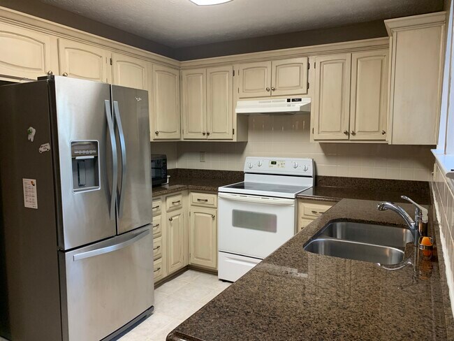 Kitchen with range, dishwasher, microwave and refrigerator. - 2078 Kelvin Dr