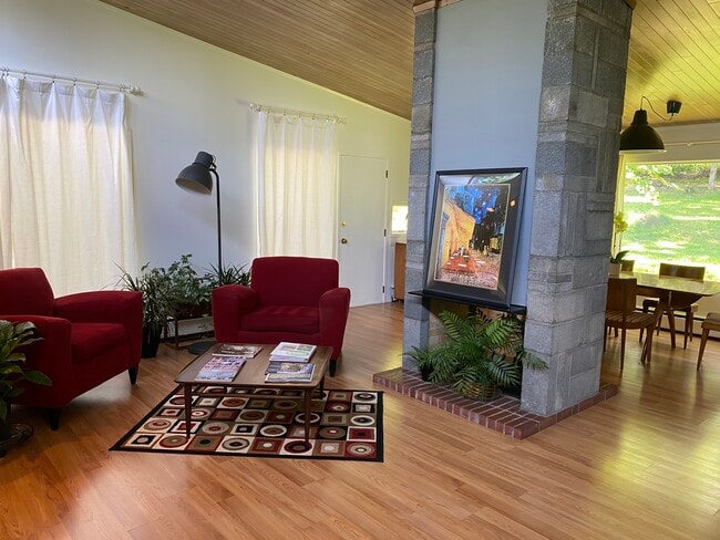 Fireplace divides space between living and dining g area - 983 Cayuga Heights Rd