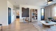 Located at 201 W Coolidge St in Phoenix, AZ, this well-appointed 2-bedroom, 2-bathroom residence offers a thoughtfully designed single-level layout with modern finishes throughout. The open-concept kitchen and living area serves as the heart of the home, where light wood-style flooring, recessed lighting, and a ceiling fan create a welcoming atmosphere. The kitchen is a standout feature, showcasing bold navy cabinetry that extends to the ceiling, a striking blue tile backsplash, stainless steel appliances, and a large center island with a white quartz countertop and pendant lighting — ideal for both cooking and casual dining. The living room offers generous natural light through large windows with patterned drapes, and opens to a private balcony. The primary bedroom features a serene blue accent wall, a walk-in closet, and a dedicated bathroom with navy vanity cabinetry. The second bedroom is equally well-sized with its own closet access. Both bathrooms continue the cohesive design language with light wood flooring and clean, modern vanities. A convenient in-unit laundry area is also included. The overall ambiance is contemporary and cohesive, blending bold color accents with warm, natural tones for a stylish yet comfortable living experience.