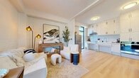 Located at 425 Fourth Street in Gananoque, Ontario, this thoughtfully designed single-floor, one-bedroom, one-bathroom home offers a clean and contemporary aesthetic throughout. The welcoming hallway entry features light hardwood flooring, soaring ceilings, a bold black-framed front door with full-height sidelights, and abundant natural light that immediately sets the tone for the rest of the home.

The living room is an inviting, light-filled space with shiplap accent walls, a decorative fireplace with a warm wood surround, and large floor-to-ceiling windows that frame lush outdoor greenery. The kitchen is bright and efficient, outfitted with light wood cabinetry, a vertical tile backsplash, sleek countertops, and a large window that draws in natural light and views of the outdoor area.

The bedroom is serene and well-proportioned, featuring the same warm hardwood flooring, textured shiplap walls, a black-framed door with transom window, a built-in sliding closet, and baseboard heating. The bathroom provides a clean, functional space with full-height white tile surrounding a soaker tub and shower combination, and neutral tile flooring.

Outside, a private fenced backyard with mature trees offers a quiet retreat. This home combines modern finishes with a comfortable, efficient layout ideal for everyday living.