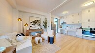 Located at 425 Fourth Street in Gananoque, Ontario, this thoughtfully designed single-floor, one-bedroom, one-bathroom home offers a clean and contemporary aesthetic throughout. The welcoming hallway entry features light hardwood flooring, soaring ceilings, a bold black-framed front door with full-height sidelights, and abundant natural light that immediately sets the tone for the rest of the home.

The living room is an inviting, light-filled space with shiplap accent walls, a decorative fireplace with a warm wood surround, and large floor-to-ceiling windows that frame lush outdoor greenery. The kitchen is bright and efficient, outfitted with light wood cabinetry, a vertical tile backsplash, sleek countertops, and a large window that draws in natural light and views of the outdoor area.

The bedroom is serene and well-proportioned, featuring the same warm hardwood flooring, textured shiplap walls, a black-framed door with transom window, a built-in sliding closet, and baseboard heating. The bathroom provides a clean, functional space with full-height white tile surrounding a soaker tub and shower combination, and neutral tile flooring.

Outside, a private fenced backyard with mature trees offers a quiet retreat. This home combines modern finishes with a comfortable, efficient layout ideal for everyday living.