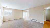 Located at 720 Shadybrook Dr in Akron, Ohio, this two-story home offers a well-organized layout spread across two levels connected by a carpeted staircase. The main level features a generously sized living area with neutral-toned carpet, warm beige walls, and a sliding glass door fitted with vertical blinds that fills the space with natural light. An adjoining dining area with a ceiling fan provides a seamless transition to the galley-style kitchen, which is equipped with warm wood cabinetry, dark granite-style countertops, a double-basin sink, and hardwood flooring. A convenient half bathroom on the main level features hardwood flooring and clean, simple finishes. Upstairs, the carpeted bedrooms offer comfortable, light-filled spaces with windows overlooking the surroundings. The primary bedroom stands out with dual closets — one standard and one walk-in — providing ample storage. A full bathroom on the upper level includes a wood vanity with dark countertop, hardwood flooring, and a full tub-shower combination. Throughout the home, a consistent warm beige color palette, neutral carpeting, and clean white trim create a cohesive and inviting atmosphere suitable for a variety of living arrangements.