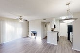 Located at 282 Big Lake Rd in Biloxi, Mississippi, this single-floor, one-bedroom, two-bathroom residence offers a well-organized layout designed for comfortable everyday living. The open-concept main area seamlessly combines the living room, dining area, and kitchen into one cohesive space. The living room features wood-look laminate flooring, a ceiling fan with light, a classic fireplace flanked by built-in shelving, and a sliding glass door with vertical blinds that opens to the patio, filling the space with natural light. The kitchen is efficiently designed with white cabinetry, a peninsula counter, black appliances including a range, microwave, refrigerator, and dishwasher, plus a stainless steel sink. A pantry provides additional storage. The bedroom is generously proportioned, complete with a ceiling fan, a window for natural light, and access to multiple closets. Two full bathrooms include tub-shower combinations with clean white tile surrounds and wood-look flooring. A dedicated laundry area adds practical convenience. Throughout the home, neutral tones and consistent laminate flooring create a cohesive, clean aesthetic. A private patio rounds out this functional and well-appointed Biloxi residence.