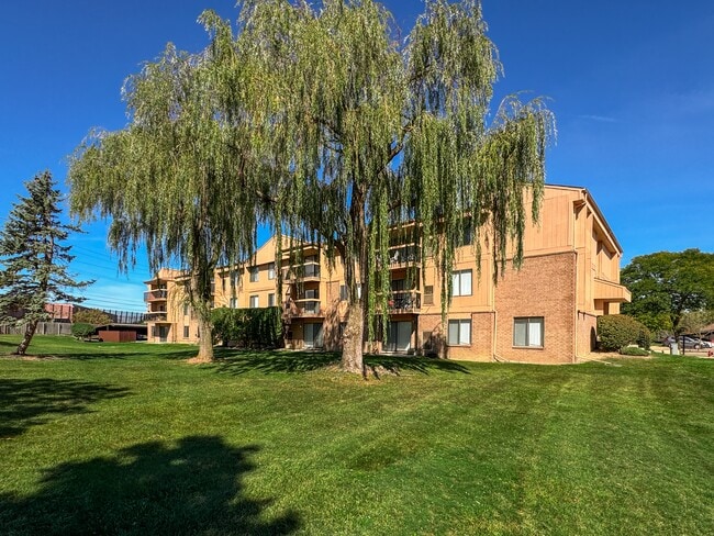 Expansive Green Space Apartment Building Exterior at Franklin River Apartments, Southfield, MI - Franklin River Apartments
