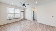 Located at 2311 Odell School Rd in Charlotte, NC, this well-appointed 3-bedroom, 1-bathroom home offers a thoughtfully designed single-floor layout with a clean, contemporary aesthetic. The open-concept kitchen and living area serves as the heart of the home, featuring light wood-style flooring, recessed lighting, and a ceiling fan that enhances airflow and comfort. The kitchen is equipped with stainless steel appliances — including a refrigerator, range, and microwave — complemented by light wood cabinetry, subway tile backsplash, neutral quartz-style countertops, and a central island with a built-in sink, offering both functionality and style. The living room benefits from large windows that invite natural light and provide views of the surrounding neighborhood. The three bedrooms are carpeted for comfort; the spacious primary bedroom includes light wood flooring and a walk-in closet with built-in shelving and hanging rods. The secondary bedrooms are bright and well-sized, each with access to natural light. The bathroom features a single vanity with ample cabinetry, a large mirror, and a glass-enclosed walk-in shower, all finished with the same light wood-tone palette that flows throughout the home.