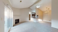 This one-bedroom, one-bathroom residence in Louisville, Kentucky, is thoughtfully designed to maximize comfort and functionality across a single floor. The living area immediately impresses with soaring vaulted ceilings accented by exposed beams and a ceiling fan, creating an open and airy atmosphere. A fireplace serves as a focal point, while plush carpet flooring and neutral wall tones contribute to a warm, inviting ambiance. Sliding glass doors lead to a private balcony, allowing natural light to pour in and providing a pleasant outdoor retreat.

The galley-style kitchen is well-appointed with rich dark cabinetry, granite countertops, a stainless steel sink, and white appliances including a refrigerator, electric range, microwave, and dishwasher. Tile flooring and a breakfast bar pass-through connect the kitchen seamlessly to the living and dining areas, which are further enhanced by a chandelier.

The bedroom is a comfortable, carpeted retreat featuring a large window with outdoor views and a closet with paneled doors. The full bathroom is finished with granite countertops, dark cabinetry, tile flooring, and a full tub-shower combination, reflecting a consistent and polished design aesthetic throughout the home.