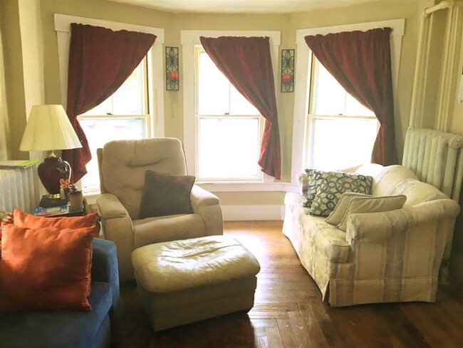 Old living room before new windows. Home is rented unfurnished. - 14 Poplar St