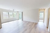 Located at 12209 Pender Creek Cir in Fairfax, VA, this single-floor home offers four bedrooms, two bathrooms, and three closets in a thoughtfully laid-out floor plan. The bright and airy living room is a standout feature, showcasing light hardwood-style flooring, a ceiling fan, large windows, and a sliding glass door that floods the space with natural light and provides views of the surrounding greenery. The open kitchen is equipped with warm wood cabinetry, stainless steel appliances, recessed lighting, and a peninsula counter finished with granite, making it both functional and inviting. The primary bedroom features hardwood-style flooring and connects to a well-appointed bathroom complete with a glass-enclosed shower, white subway tile surround, granite vanity countertop, and wood-toned cabinetry. The second bathroom mirrors this quality with a subway-tiled tub-shower combination and matching granite vanity. The remaining bedrooms are carpeted and naturally lit, providing comfortable and versatile living spaces. Clean white walls, consistent finishes, and an abundance of natural light throughout give the home a fresh, move-in-ready feel.