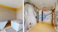 Located at 45 NE 27th St in Miami's vibrant Edgewater district, this single-floor wellness suite offers a thoughtfully curated spa experience. The space is immediately distinguished by its dramatic, floor-to-ceiling abstract ink murals that flow continuously throughout the corridors and rooms, creating an immersive, artistic atmosphere from the moment you enter.

The main corridor leads guests through the facility, with large-format porcelain tile flooring underfoot and recessed lighting above. Warm natural light filters in through floor-to-ceiling windows and a glass-panel balcony door, framing city and skyline views that enhance the sense of openness.

The plunge pool lounge is lined with warm horizontal wood-tone tile, ambient LED cove lighting along the upper walls, and houses a freestanding soaking tub and a covered plunge unit, all set against the backdrop of an outdoor balcony with open city views. The sauna is accessed through a wood-framed glass door, maintaining the suite's design continuity.

A dedicated changing area features built-in wood lockers, open cubbies, and a matching bench, providing functional yet elegant storage. Throughout the suite, the cohesive use of natural wood tones, soft neutral tiles, and bold artistic murals creates a calm yet visually engaging wellness environment.