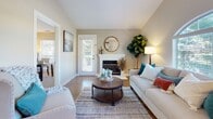This single-story home in Antioch, California offers a well-designed layout with a warm, neutral aesthetic carried consistently throughout its rooms. The living room serves as a welcoming centerpiece, featuring hardwood-style flooring, a white-mantled fireplace, and a distinctive arched window that allows generous natural light to fill the space. Vaulted ceilings add a sense of openness and airiness to the room.

The galley-style kitchen is efficiently organized, with white cabinetry, granite-look countertops, stainless steel appliances, and a deep double sink. The layout maximizes counter and storage space while maintaining a clean, bright atmosphere.

The bedrooms continue the home's soft, calming palette, with plush carpeting and vaulted ceilings that lend each room a spacious feel. Windows overlooking mature trees provide a serene, natural backdrop. The primary bathroom features a dual-sink vanity with white cabinetry, granite countertops, tile flooring, and well-lit mirrors, offering a functional yet refined space. A second bathroom includes a tub-shower combination with decorative accents and matching granite countertops.

Overall, the home presents a cohesive, comfortable environment with thoughtful finishes and abundant natural light throughout.