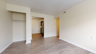 This single-floor unit at 1250 Crescent Heights Rd in Marion, Ohio offers a straightforward, functional layout with consistent wood-look plank flooring running throughout the space. The living area is open and connects directly to the kitchen, creating a cohesive flow between the two spaces. A built-in open closet is accessible from the main living area, providing convenient storage without the need for additional furniture.

The kitchen is equipped with dark cabinetry on both the upper and lower sections, paired with laminate countertops featuring a stone-like pattern. A black refrigerator anchors the space, and the L-shaped cabinet configuration maximizes available counter and storage space. An adjacent dining area offers additional room for everyday use.

The bedrooms feature the same wood-look flooring and neutral wall tones, with windows that allow natural light to enter. Closet space is available within the sleeping areas. The bathroom includes a full tub-shower combination unit, a toilet, and a vanity, finished with matching wood-look flooring. Clean white trim and neutral wall colors are consistent throughout, contributing to a simple, cohesive aesthetic across the unit.