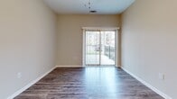 This contemporary apartment offers 860 square feet of thoughtfully designed living space. The layout includes two bedrooms, two full bathrooms, a combined kitchen and living area, and a dedicated laundry room. The primary bedroom is spacious at 170 square feet, providing ample room for relaxation.

The interior showcases a blend of modern finishes. Wood-look flooring graces the main living areas and bathrooms, while plush carpeting adds comfort to the bedrooms. The kitchen boasts sleek stainless steel appliances, dark wood cabinetry, and granite countertops, creating an efficient and stylish cooking space.

Natural light floods the apartment through large windows, some fitted with horizontal blinds for privacy control. A sliding glass door in the living area leads to an outdoor space, expanding the living area and providing a connection to the outdoors.

The bathrooms feature clean lines with modern fixtures, including vanities with ample storage. Ceiling fans in the bedrooms offer additional comfort and air circulation. The neutral color palette throughout provides a versatile backdrop for various decor styles.

Located at 11143 Hyde Pointe Ct in Charlotte, NC, this single-story apartment combines modern amenities with a practical layout, ideal for contemporary urban living.