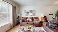 This single-floor, 2-bedroom, 1-bathroom residence at 1451 Clough St in Bowling Green, Ohio offers a functional and well-organized layout. The entrance opens toward a carpeted living room that provides a comfortable, open feel, with a window allowing natural light to brighten the space. Textured ceilings are consistent throughout the common areas, adding a classic residential character.

The kitchen is laid out in a galley style, featuring warm oak cabinetry, a double-basin sink, white appliances including a refrigerator and range, and tile flooring. A separate dining area adjoins the kitchen, supporting everyday convenience. The living and dining areas flow naturally together, making efficient use of the available space.

The primary bedroom is a well-proportioned room featuring carpeted floors, two double closets with wood bi-fold doors, offering notable storage capacity. The secondary bedroom includes carpeted floors and a window with exterior views, and is well-suited as a guest room or home office. The shared bathroom features tile flooring, a wood-framed vanity mirror, and a louvered closet door providing additional storage access directly from the hallway.