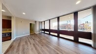 Located at 400 S Fourth St in the heart of downtown St. Louis, Missouri, Unit 406 is a modern urban residence offering a thoughtfully designed single-floor layout. The expansive living area is a standout feature, boasting a full wall of floor-to-ceiling windows framed in rich dark frames that flood the space with natural light and frame direct views of Busch Stadium and the surrounding cityscape. Smooth hardwood-style flooring runs throughout the main living areas, lending warmth and continuity to the open layout.

The kitchen is well-appointed with rich dark cabinetry, granite countertops, stainless steel appliances including an electric range, a double-basin sink, and tile flooring — providing both style and function. The bedrooms are comfortably sized, featuring plush carpeting, neutral gray walls, and closet access, offering a quiet retreat from the bustling city below.

Both bathrooms are finished with tile flooring, granite-topped vanities, large mirrors, and combination tub/shower units equipped with accessibility features including grab bars and open vanity clearance. Recessed lighting throughout the main living areas completes the clean, contemporary aesthetic of this well-positioned downtown St. Louis residence.