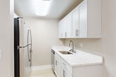 Located at 19719 Crystal Rock Dr in Germantown, MD, this single-floor, 2-bedroom, 2-bathroom home offers a clean, modern aesthetic with a neutral color palette and light wood-style flooring throughout. The layout is efficient and well-organized, making the most of every square foot.

The generously sized primary bedroom is a standout feature, offering ample room for a full furniture arrangement. It benefits from natural light through a window framing views of surrounding greenery, and includes a wall-mounted HVAC unit for independent climate control. A set of sleek, floor-to-ceiling sliding panel closet doors adds a contemporary touch to the room.

The second bedroom is similarly bright, with warm natural light and a neutral taupe wall finish that complements the light flooring. Both bedrooms share access to two well-appointed bathrooms. One bathroom features a full tub-shower combo with clean white tile surround, while the other includes a white vanity with multiple drawers and brushed nickel hardware.

The main living area is bright and open, with crown molding accenting the ceiling and a large sliding glass door that opens to a private deck overlooking lush trees — providing a seamless indoor-outdoor connection. A dedicated closet rounds out the functional layout. The home's cohesive finishes and abundant natural light create a calm, inviting atmosphere throughout.