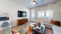 Located in Glendale, Arizona, this 1-bedroom, 2-bathroom single-floor residence offers a thoughtfully designed layout that maximizes every square foot. Wood-look plank flooring runs throughout, providing a cohesive and contemporary aesthetic across all rooms.

The kitchen is a standout feature, equipped with stainless steel appliances including a refrigerator, range, microwave, and dishwasher. White shaker cabinetry, white quartz countertops, and a single-basin sink create a clean, modern workspace. A kitchen island with seating adds both functionality and a casual dining option.

The living room features a ceiling fan, large windows that invite natural light, and a glass door providing outdoor access. Accent walls in sage green add a pop of color and visual depth to the space.

The primary bedroom offers a comfortable footprint, highlighted by a bold deep-green accent wall, a ceiling fan, large windows with exterior views, and a sliding-door closet. The room connects conveniently to the hallway.

The two bathrooms include a full bath featuring a glass-door walk-in shower, a white vanity with quartz countertop, and wood-look flooring. The second bathroom provides an additional half-bath configuration. The hallway connects all areas of the home efficiently, completing this well-appointed Glendale residence.
