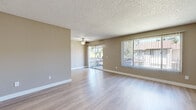 Located at 1000 Pine Ave in Redlands, CA, this 3-bedroom, 1-bathroom unit offers a practical and comfortable single-floor layout. The bright living room is a welcoming centerpiece, featuring wood-look laminate flooring, a ceiling fan, and a textured ceiling. A sliding glass door opens to a private balcony, while a large window with vertical blinds fills the space with natural light and outdoor views of mature trees.

The galley-style kitchen is efficiently designed with white shaker cabinetry, granite-look countertops, a gas range, and a built-in sink — all complemented by light wood-look flooring and ample overhead storage.

The three bedrooms are carpeted for comfort and each features vertical-blind windows that bring in natural light and neighborhood views. The primary bedroom includes mirrored sliding closet doors that add depth to the room. The additional bedrooms are well-proportioned with clean neutral walls and textured ceilings.

The bathroom is neatly appointed with a full tub-shower combo, a vanity with granite-look countertops, white cabinetry, and wood-look tile flooring. A hallway connects the main areas, providing a logical and functional flow throughout the unit. The overall aesthetic is clean, neutral, and move-in ready.