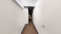 Located at 218 6th Ave in downtown Des Moines, Iowa, this single-floor entertainment suite is a fully immersive cinematic experience. The layout flows from a narrow entry corridor into a series of thoughtfully designed rooms unified by a consistent dark, dramatic aesthetic featuring black drop-tile ceilings, neutral carpeting, and curated movie poster artwork throughout.

The centerpiece is a dedicated home theater room with tiered seating, rows of plush black leather power recliners with cup holders, and a large projection screen. Recessed spotlighting illuminates classic film posters adorning the dark-toned walls, creating an authentic cinema ambiance. Adjacent to the theater is a spacious lounge area featuring a red leather sofa, a bar counter with sleek black barstools, and additional wall-mounted movie memorabilia alongside a popcorn machine — ideal for pre-show gatherings.

The generously sized bedroom accommodates multiple guests with two queen beds and a bunk bed, all accented by more iconic film posters and a black ceiling that carries the cinematic theme throughout. A connecting hallway displays vibrant pop-art prints of Des Moines landmarks, adding a local touch. The space is well-suited as a unique short-term rental or entertainment venue in the heart of Des Moines.