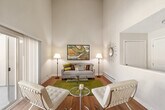 Located at Heritage Gardens in Sunnyvale, California, this 3-bedroom, 2-bathroom residence offers a well-designed single-floor layout that makes efficient use of its space. The living room is an immediate standout, boasting dramatic vaulted ceilings that lend a sense of openness and airiness well beyond its footprint. Hardwood-style flooring runs throughout the main living areas, and a sliding glass door floods the space with natural light while providing direct access to a private balcony with outdoor views. The adjacent dining area is bright and welcoming, featuring a large window that frames views of the surrounding neighborhood and is complemented by a ceiling fan overhead. The galley-style kitchen is thoughtfully outfitted with light wood cabinetry, granite-style countertops, a double sink, and stainless steel appliances. Each of the three bedrooms offers a comfortable retreat with plush carpeting, sliding closet doors, and windows that invite natural light. The two bathrooms are consistently finished with warm wood vanities, granite-style countertops, and tub-shower combinations with curved curtain rods. Throughout the home, a neutral color palette creates a calm, cohesive ambiance suited for everyday living in the heart of Silicon Valley.