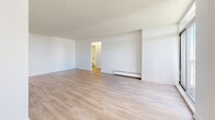 Located at 60 Exeter Rd in Ajax, Ontario, this one-bedroom, one-bathroom unit offers a well-organized layout across a single floor. Light-toned hardwood-style flooring runs throughout, lending a clean, cohesive look to the entire space.

The open living room is bright and airy, featuring a sliding glass door that brings in abundant natural light and provides access to an outdoor area. A baseboard heating unit ensures year-round comfort. The space flows directly into the kitchen, which is outfitted with white shaker-style cabinetry, dark countertops, a subway tile backsplash, and a full suite of stainless steel appliances including a refrigerator, stove, and over-the-range microwave.

The bedroom is a comfortable size, featuring a window with an outdoor view, a baseboard heater, and a closet with a clean panel door. The hallway connects the main living areas efficiently to the rest of the unit.

The bathroom is finished with classic white subway tile surrounding a full soaker tub with an overhead shower, complemented by neutral floor tile and chrome fixtures, creating a timeless and functional space. Throughout the unit, crisp white walls and consistent flooring create a bright, move-in ready environment.
