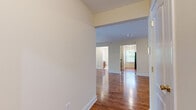 This single-floor residence offers a thoughtfully designed open layout with warm hardwood flooring extending throughout the main living areas and bedrooms. The entryway opens into a generous living space with elevated ceilings, creating an airy, welcoming atmosphere. Sliding glass doors lead to a private balcony overlooking lush greenery, allowing natural light to flood the interior.

The kitchen is well-equipped with rich wood cabinetry, granite countertops, a stainless steel sink, and a dishwasher. A window above the counter area brings in additional natural light, enhancing the functional workspace.

The bedrooms are comfortably sized and finished with polished hardwood floors and large windows that frame views of surrounding trees and neighboring architecture, providing a bright and peaceful environment.

Two full bathrooms serve the residence, each featuring a tub-shower combination, tile flooring, a wood vanity with granite countertop, and a mirror. One bathroom includes a window with views of mature trees, adding a refreshing natural element.

Overall, the space presents a clean, neutral palette with cream-toned walls, white trim, and consistent warm wood finishes, resulting in a cohesive and inviting interior well-suited for comfortable everyday living.