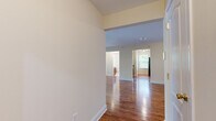This single-floor residence offers a thoughtfully designed open layout with warm hardwood flooring extending throughout the main living areas and bedrooms. The entryway opens into a generous living space with elevated ceilings, creating an airy, welcoming atmosphere. Sliding glass doors lead to a private balcony overlooking lush greenery, allowing natural light to flood the interior.

The kitchen is well-equipped with rich wood cabinetry, granite countertops, a stainless steel sink, and a dishwasher. A window above the counter area brings in additional natural light, enhancing the functional workspace.

The bedrooms are comfortably sized and finished with polished hardwood floors and large windows that frame views of surrounding trees and neighboring architecture, providing a bright and peaceful environment.

Two full bathrooms serve the residence, each featuring a tub-shower combination, tile flooring, a wood vanity with granite countertop, and a mirror. One bathroom includes a window with views of mature trees, adding a refreshing natural element.

Overall, the space presents a clean, neutral palette with cream-toned walls, white trim, and consistent warm wood finishes, resulting in a cohesive and inviting interior well-suited for comfortable everyday living.