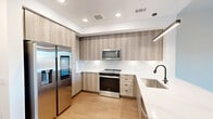 This contemporary 580 square foot apartment in Atlanta offers a thoughtfully designed living space. The open-concept layout seamlessly integrates the kitchen, living room, and dining area, creating a sense of spaciousness. The gourmet kitchen is a standout feature, boasting sleek wood-grain cabinetry, stainless steel appliances, and a convenient built-in microwave. A large island with a sink serves as both a food preparation area and casual dining spot.

The living room is bathed in natural light from floor-to-ceiling windows, which also provide access to a private balcony offering city views. The 130 square foot bedroom continues the modern aesthetic with ample space and large windows. The bathroom impresses with a long vanity, large mirror, and a combination of tile and wood-look flooring.

Throughout the apartment, warm wood flooring contrasts beautifully with crisp white walls, creating a fresh and inviting atmosphere. Recessed lighting and pendant fixtures add to the contemporary feel. A closet and additional storage spaces ensure practicality. This well-designed apartment maximizes its 580 square feet, offering a perfect blend of style and functionality in the heart of Atlanta.
