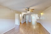 Located at 750 Harding Blvd in Baton Rouge, Louisiana, this single-story 2-bedroom, 1-bathroom unit offers a practical and comfortable layout. Light wood-style flooring runs throughout the entire space, creating a clean, cohesive look. The open living area is bright and airy, featuring a ceiling fan with light fixture and textured ceiling, with easy sightlines into the kitchen. The galley-style kitchen is efficiently designed with white cabinetry, light granite-style countertops, a stainless steel sink, and white appliances including a coil-top range and full-size refrigerator. A window at the end of the kitchen brings in natural light and garden views. Both bedrooms are well-proportioned, each equipped with a ceiling fan and window, with the primary bedroom offering a comfortable footprint and outdoor views. The closet provides dedicated storage space. The full bathroom is clean and functional, featuring a tub-shower combination, a vanity with granite-style countertop and mirror, and wood-style flooring. Wall sconces are found in select areas, adding warm accent lighting. The overall ambiance is bright, neutral, and move-in ready.