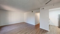 Located at 316 S Lake Lamond Rd in Longview, TX, this single-floor, one-bedroom, one-bathroom unit offers a practical and comfortable layout across a compact but efficient footprint. The living room serves as the welcoming heart of the home, featuring light wood-look vinyl flooring, a textured ceiling, a ceiling fan, and a large picture window that fills the space with natural light and offers views of the surrounding community. The open flow connects seamlessly to the galley-style kitchen, which is outfitted with crisp white cabinetry, granite-look countertops, a stainless steel double sink, a full-size refrigerator, and an electric range — providing ample functionality for everyday cooking. The bedroom is carpeted for warmth and comfort, equipped with a ceiling fan, a window for natural light, a walk-in closet with built-in shelving, and additional corner wall shelves for extra storage. A hallway with a dedicated closet connects the living spaces to the full bathroom, which features a tiled shower-tub combo, overhead cabinetry, and wood-look flooring. Neutral tones and clean finishes throughout lend the space a fresh, move-in-ready appearance.