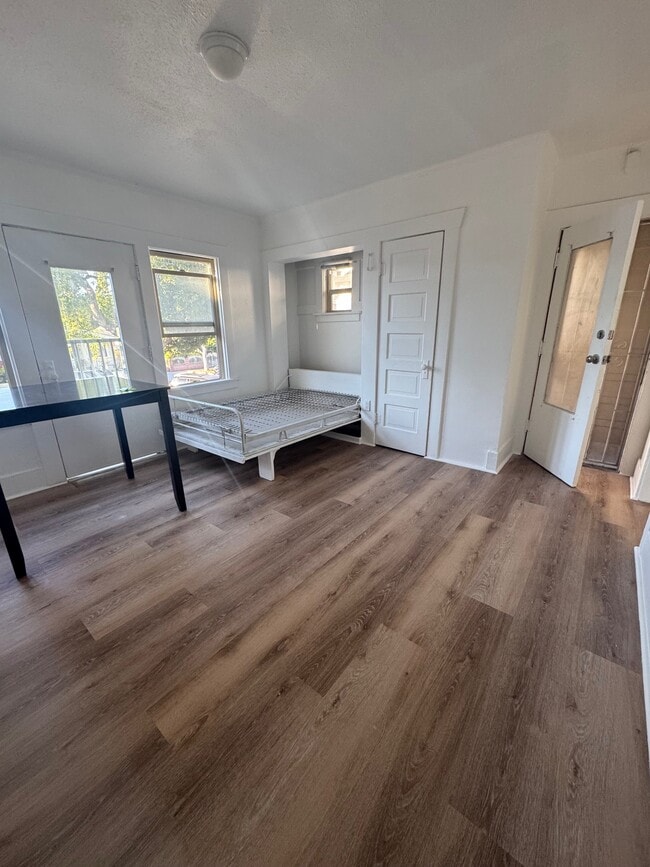 living room with murphy bed pulled down - 420 E 14th St