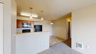 Located at 802 Garfield Road in Airway Heights, WA, this single-floor home offers three bedrooms and two bathrooms within a well-organized, efficiently laid-out floor plan. The living room is a welcoming, carpeted space with a wall-mounted heating and cooling unit and a sliding glass door that opens to a private balcony, providing pleasant outdoor views and natural light. The kitchen is functional and well-equipped, featuring warm oak cabinetry, light countertops, a stainless steel sink, and black appliances including a refrigerator, electric range, and built-in microwave. Tile flooring throughout the kitchen lends a clean, practical finish. The three bedrooms are carpeted with neutral-toned walls and window blinds that allow for natural light and privacy. The primary bedroom offers a comfortable, cozy footprint. Both bathrooms feature tile flooring and warm wood vanities. The full bathroom includes a shower-tub combination, while the second bathroom provides a single vanity with a large mirror and baseboard heating. The overall aesthetic throughout the home is clean and neutral, creating a move-in ready environment suitable for a variety of lifestyles.