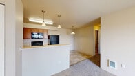 Located at 802 Garfield Road in Airway Heights, WA, this single-floor home offers three bedrooms and two bathrooms within a well-organized, efficiently laid-out floor plan. The living room is a welcoming, carpeted space with a wall-mounted heating and cooling unit and a sliding glass door that opens to a private balcony, providing pleasant outdoor views and natural light. The kitchen is functional and well-equipped, featuring warm oak cabinetry, light countertops, a stainless steel sink, and black appliances including a refrigerator, electric range, and built-in microwave. Tile flooring throughout the kitchen lends a clean, practical finish. The three bedrooms are carpeted with neutral-toned walls and window blinds that allow for natural light and privacy. The primary bedroom offers a comfortable, cozy footprint. Both bathrooms feature tile flooring and warm wood vanities. The full bathroom includes a shower-tub combination, while the second bathroom provides a single vanity with a large mirror and baseboard heating. The overall aesthetic throughout the home is clean and neutral, creating a move-in ready environment suitable for a variety of lifestyles.